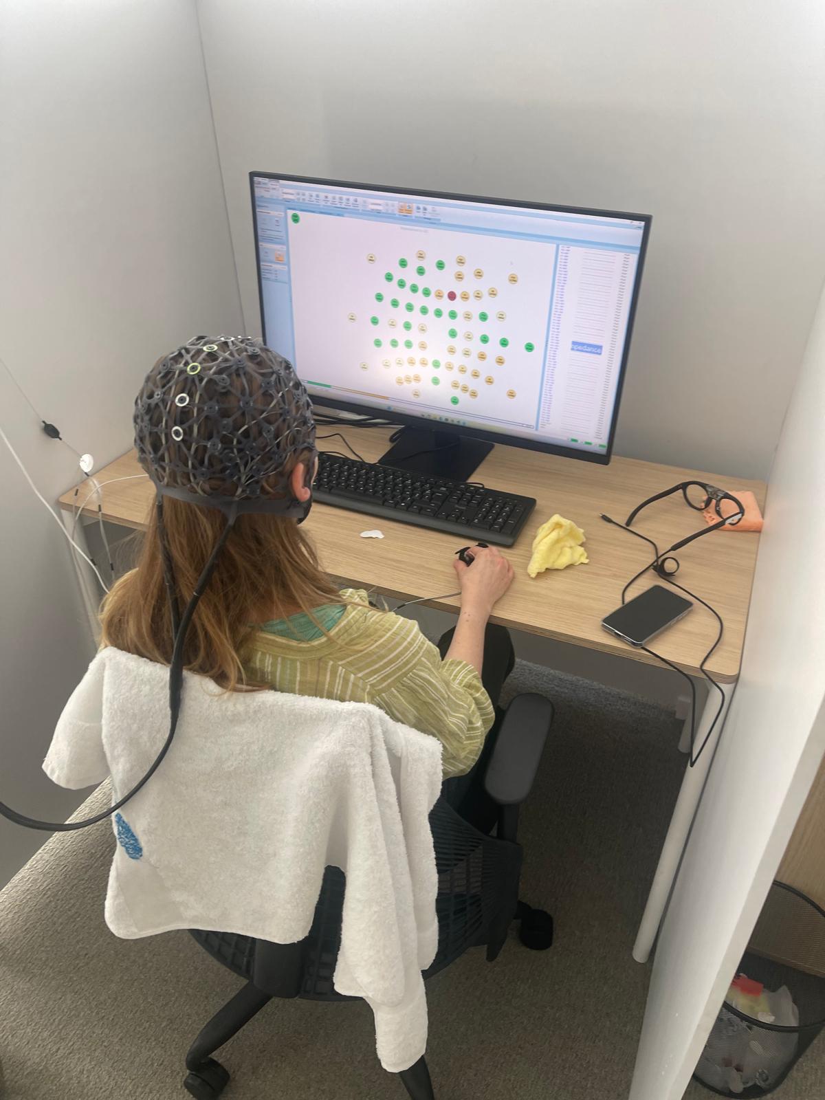 HABS neuroscience team recording a subject with an EEG cap inside the Neuro Lab
